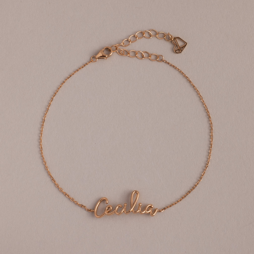 Cursive Name Bracelet in Rose Gold featuring "Cecilia" in elegant script on a neutral background. This personalized name jewelry is perfect for daily wear or as a thoughtful gift.
