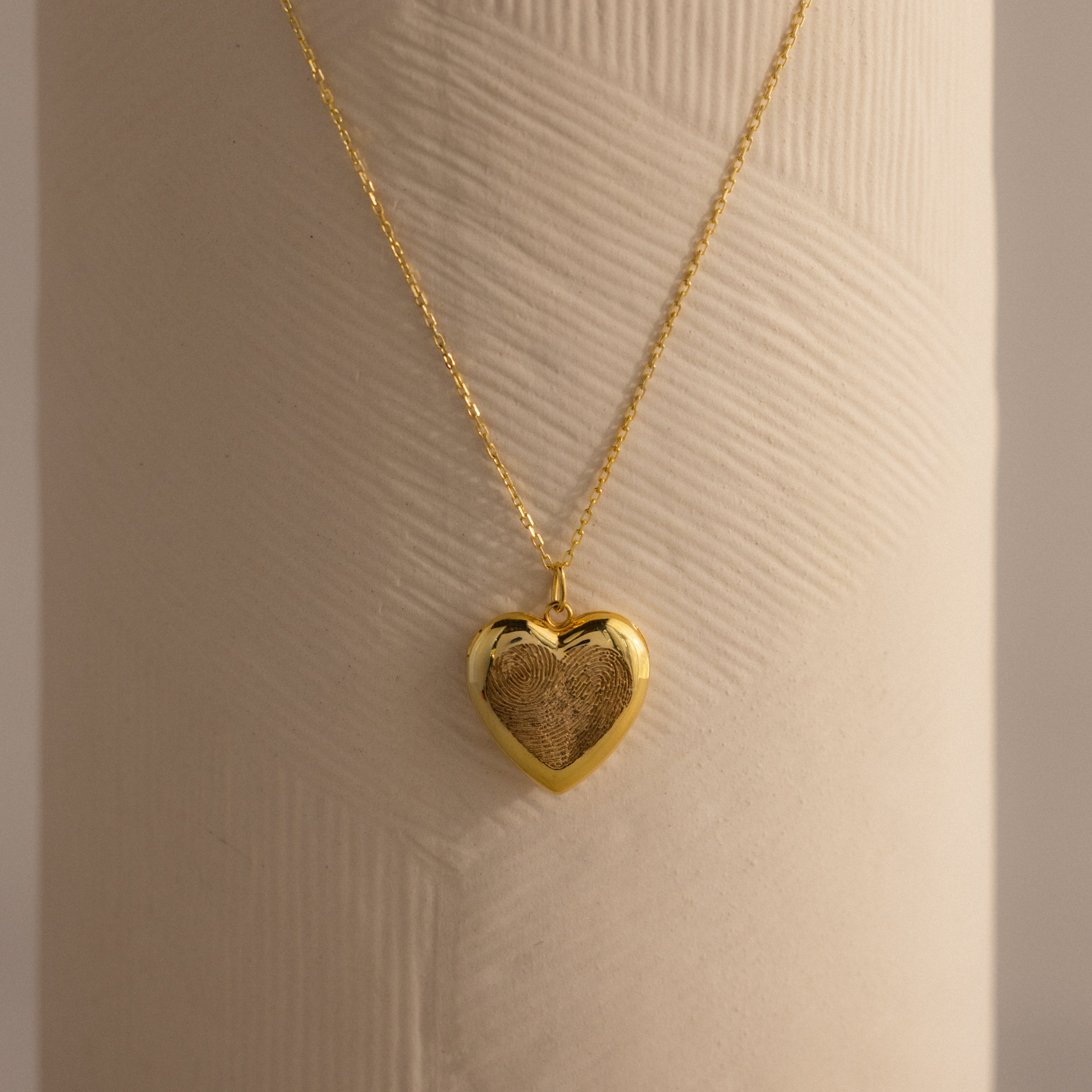 Close up of our Fingerprint Heart Locket Necklace in Gold