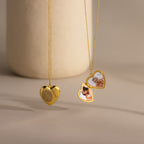 Flatlay showcasing the front and inside of our Fingerprint Heart Locket Necklace in Gold