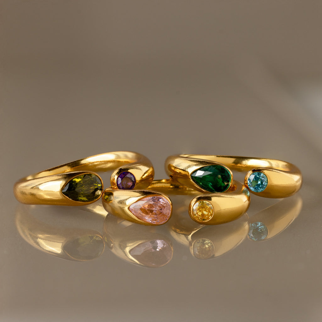 The Toi et Moi Birthstone Signet Ring shines with vibrant green, pink, blue, yellow, and purple gemstones. Celebrate your unique style and story with this customizable gemstone ring.