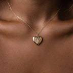 Close up of a model wearing our our Fingerprint Heart Locket Necklace in Gold