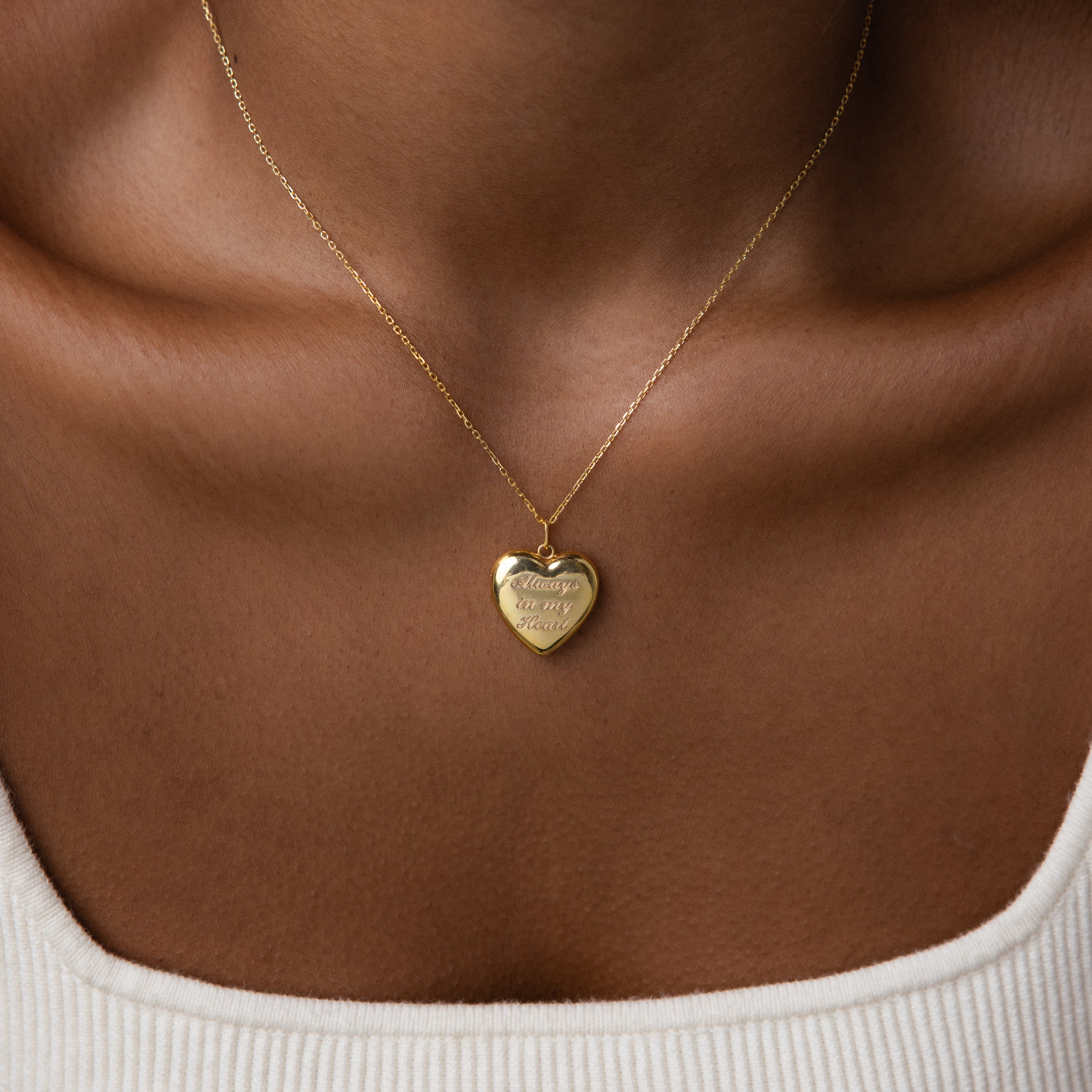 Close up photo of a model wearing our Handwriting Heart Locket Necklace in Gold 