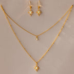 The Opal Star Necklace & Earrings Set includes a gold-layered necklace with opal star pendants and matching star-shaped earrings, beautifully displayed on a beige surface.