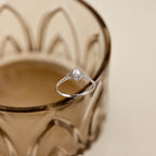 The Vintage Pave Pearl Ring in Sterling Silver showcases a central pearl with pavé diamonds in a square setting on a reflective gold band—an elegant and exquisite Christmas gift choice.