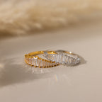 The Art Deco Diamond Ring and a silver statement gemstone ring are displayed side by side on a neutral surface.
