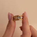 Two hands hold the Agate Diamond Rings Set, featuring sparkling diamonds and a rectangular agate stone, against a beige background—showcasing this stunning vintage-inspired jewelry piece.