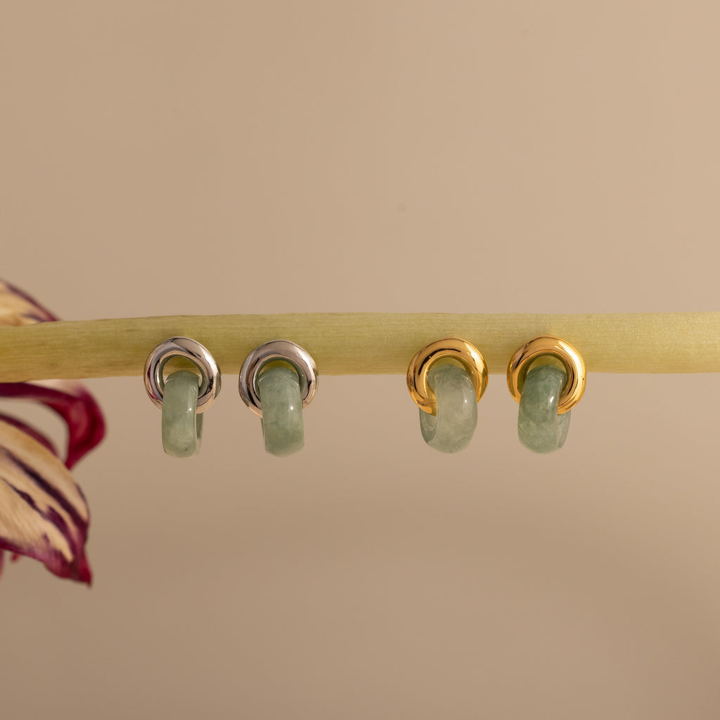Two pairs of Jade Halo Drop Studs, one silver and one gold, featuring smooth green jade.