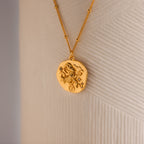 Close up of a Gold 3D Aries Zodiac Coin Pendant Necklace with small CZ gemstones, attached to a dainty satellite chain.