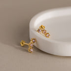 Sapphire Cluster Flatback Studs with pink gemstones are displayed on a round white dish against a beige background.