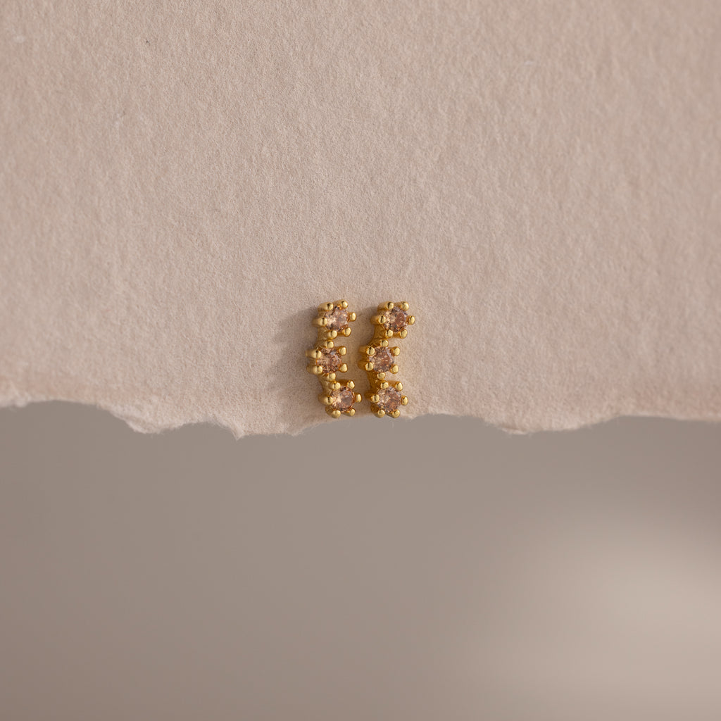 Topaz Cluster Flatback Studs are displayed on torn beige paper against a neutral background.