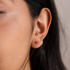 Close-up of an ear wearing Teardrop Pink Tourmaline Flatback Studs, with long dark hair partially visible.