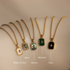 A row of necklaces featuring various designs, including a crystal pendant and the North Star Gemstone Necklace in 18K Gold.