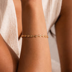 Model wearing the Mini Mariner Chain Bracelet in gold with rounded mariner-style links.