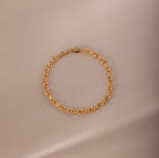Mini Mariner Chain Bracelet in gold with rounded mariner-style links, placed on a neutral background.