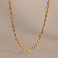 Gold mariner chain necklace with polished oval links, displayed against a neutral beige background.