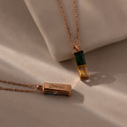 The Duo Birthstone Name Necklace in Rose Gold features two stylish pendants: one with green and yellow birthstones, and another as a custom-engraved bar reading "Emma"—a stunning piece of personalized jewelry.