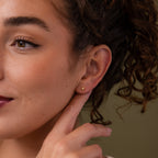 Close-up of a model wearing our Starlight Flatback studs