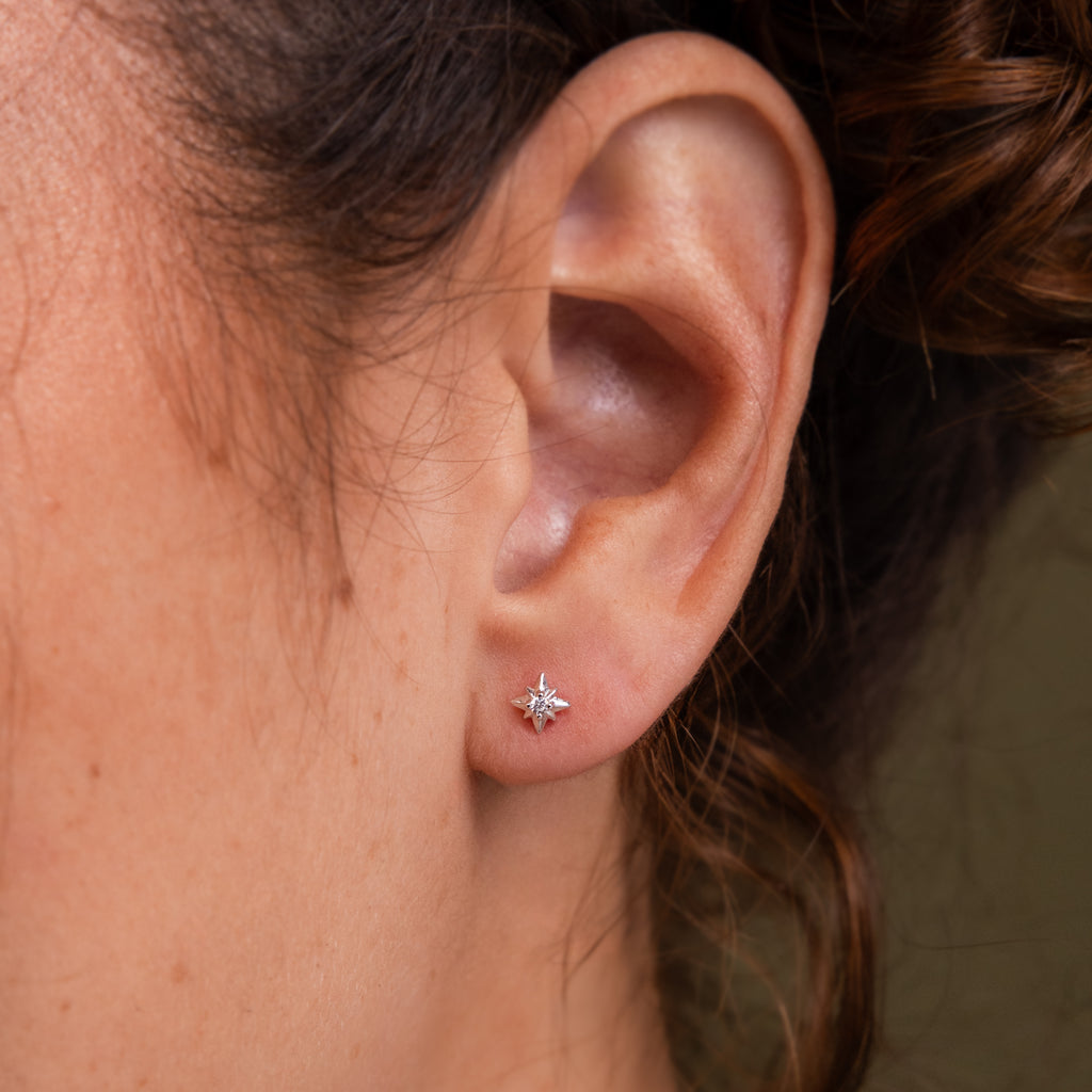 Close up of a model wearing our Starlight Flatback Studs in Silver