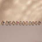 Athena Alexandrite Huggies—silver hoops with star-shaped, multicolor gemstones—make stylish personalized jewelry or pair beautifully with birthstone earrings for a unique, meaningful look.