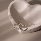 Silver heart shaped hoop earrings on a heart-shaped stone
