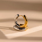 The Mixed Metal Chunky Hoops feature both gold and silver tones, making these bold hoop earrings a striking addition to any outfit.