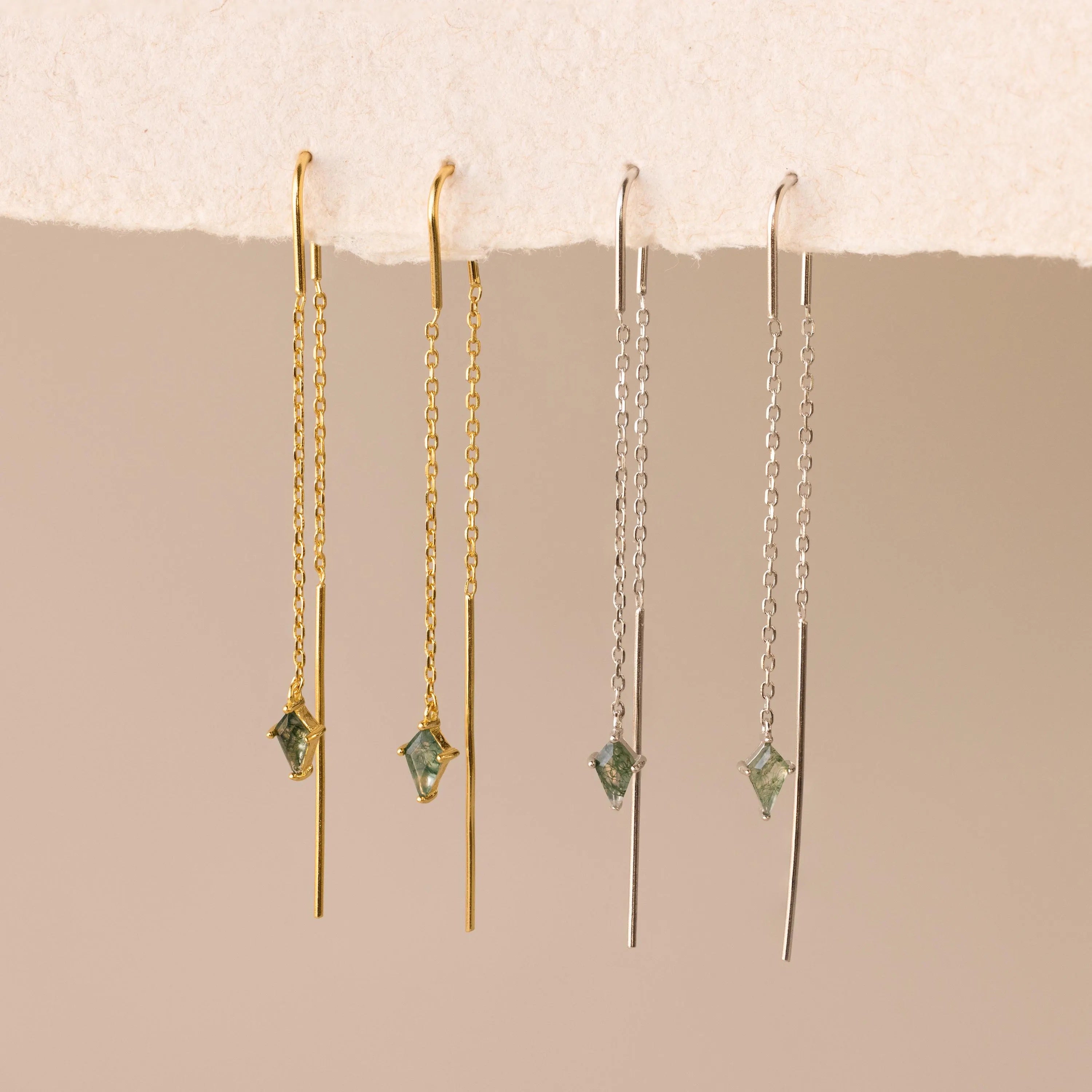 Two pairs of Agate Threader Earrings—one gold, one silver—each with a green gemstone and delicate chain for a modern look.