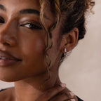 Model wearing silver CZ diamond drop earrings with four marquise-cut stones.