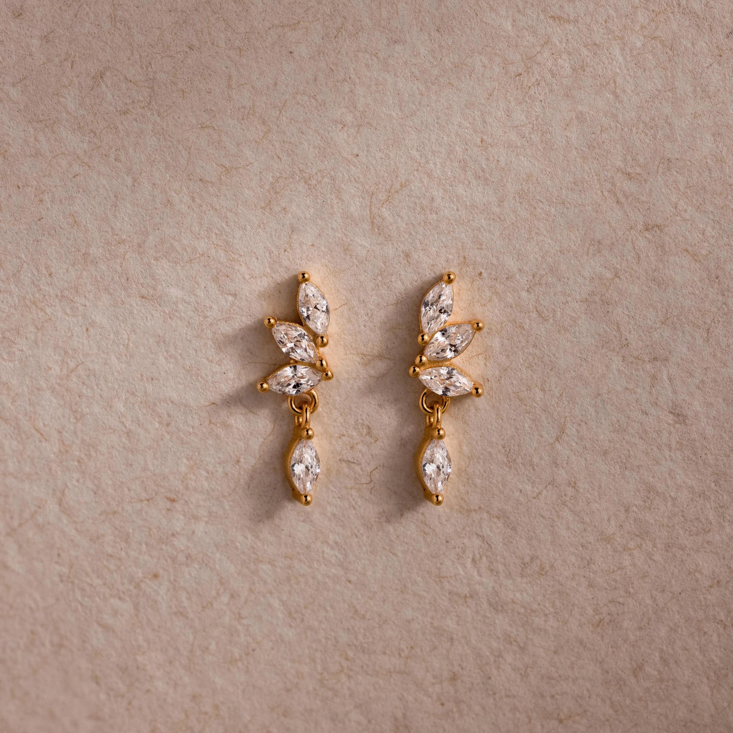 Gold CZ diamond drop earrings with four marquise-cut stones.