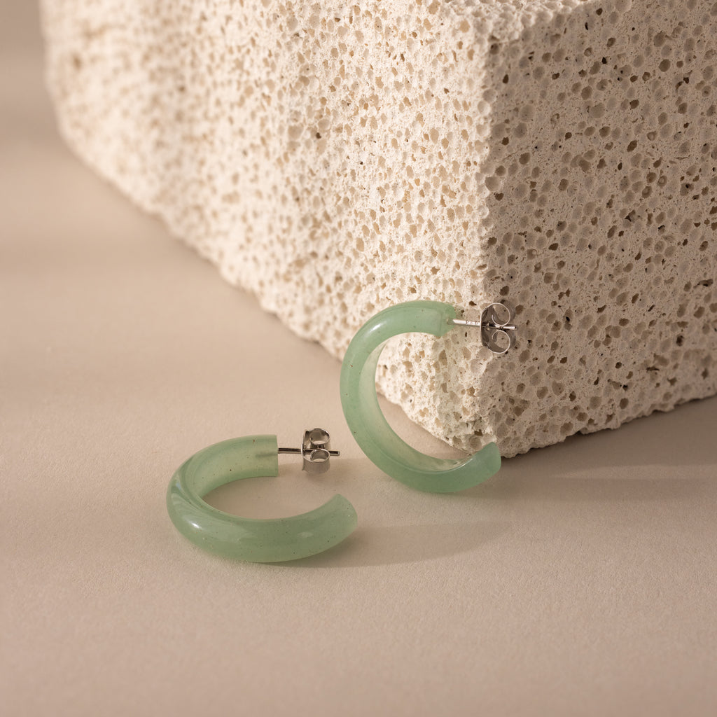 Close-up of Jade Hoop Earrings in silver, featuring a chunky hoop design with green jade and butterfly back closures.