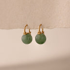 Gold Jade Dome Drop Earrings featuring rounded green gemstones on dainty hoops, displayed on a neutral paper.