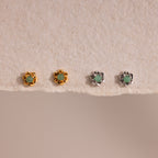Set of four Mini Jade Flower Studs—two gold, two silver—with green stones, displayed on textured beige paper. These delicate earrings add an elegant touch to any outfit.