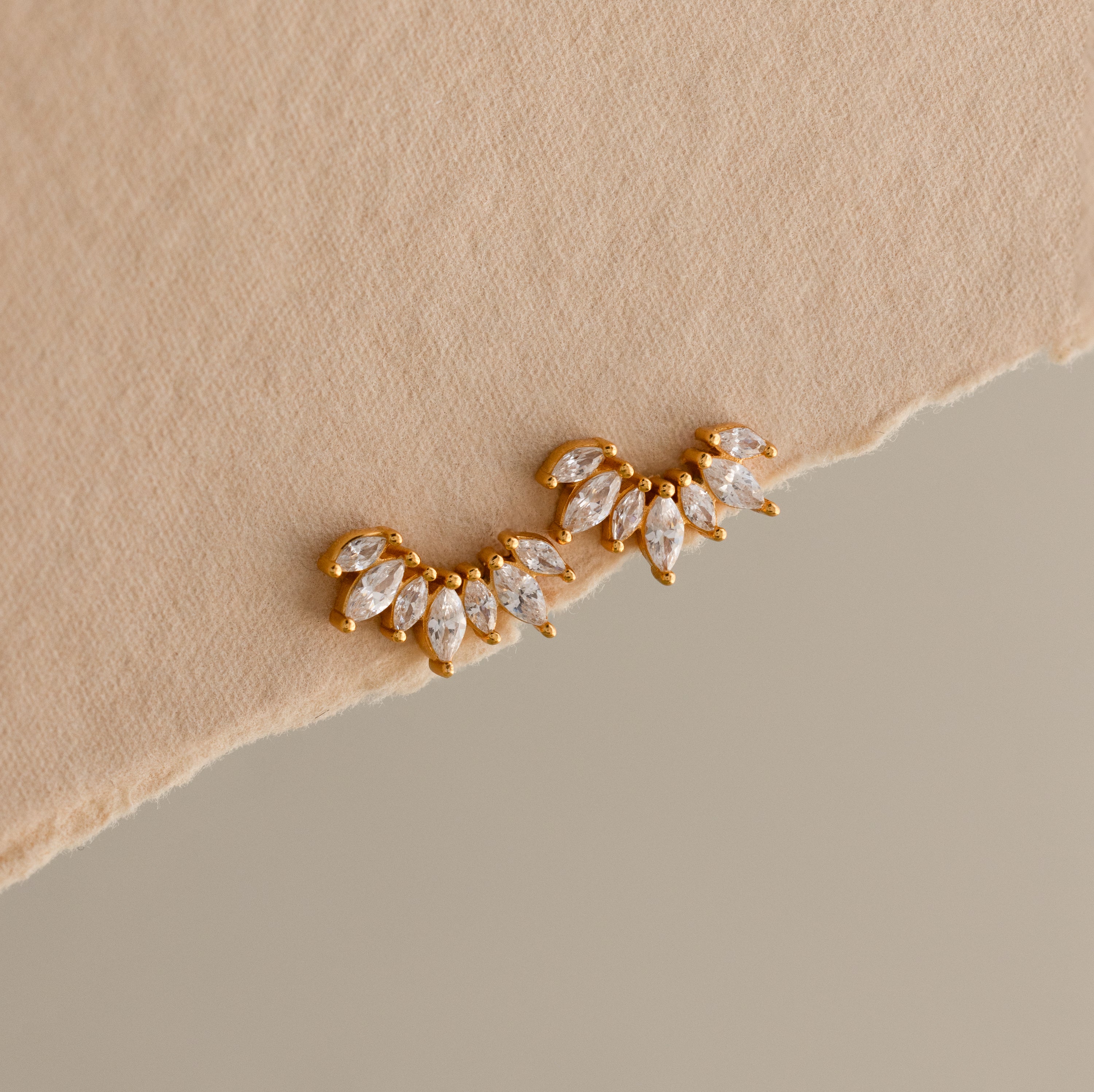 Elevate your look with Marquise Diamond Arc Climbers in 18K Gold, featuring clusters of sparkling marquise-shaped diamonds set in a stunning gold arc design.