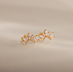 Marquise Diamond Arc Climbers in 18K Gold featuring leaf-shaped marquise stones arranged in a graceful arc, displayed on a neutral background.