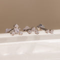 Three silver crystal cluster flat back stud earrings displayed on a white surface, showing graduated two, three, and four stone designs.