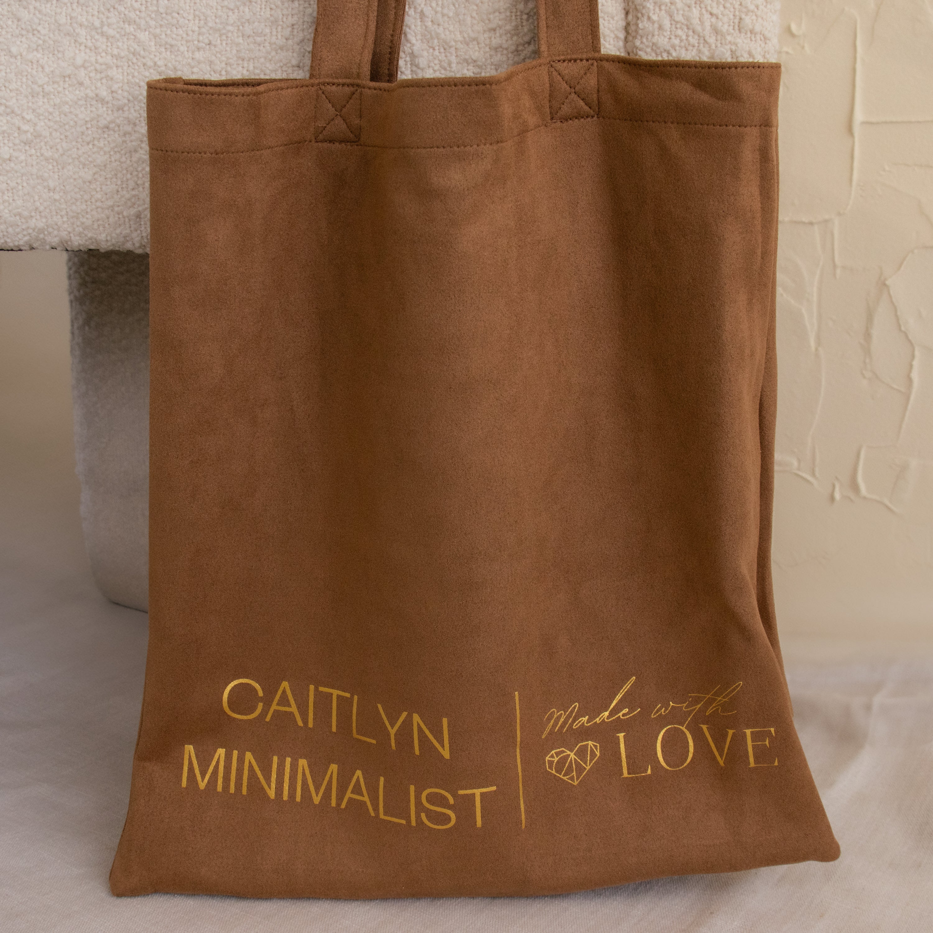 Brown tote bag with gold "CAITLYN MINIMALIST Made with LOVE" text and a heart graphic. Ideal for essentials or as a Free Gift of Choice for tote bag lovers.