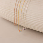 The Toi et Moi Infinity Heart Birthstone Necklace features three delicate chain necklaces in rose gold, gold, and silver with colorful gemstone pendants—ideal for meaningful, personalized jewelry.