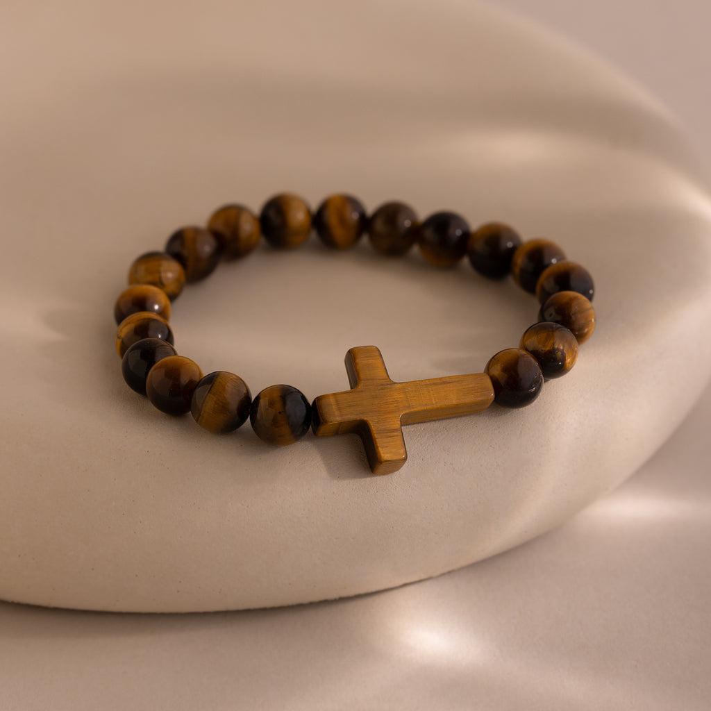 Tigers Eye Cross Bracelet featuring round polished tiger's eye beads and a horizontal tiger's eye cross charm, displayed on a neutral background.