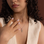 Model wearing a silver chain necklace with a marquise jade stone cross pendant with a CZ diamond center.