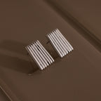 Ribbed Earrings in White Gold featuring a textured column design with vertical ridges, displayed on a brown textured surface—an elegant piece of contemporary jewelry.