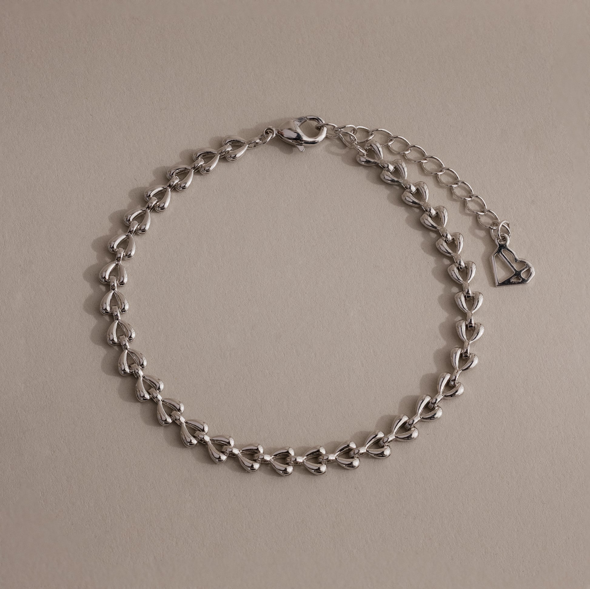 Silver Tiny Link Heart Bracelet displayed on a neutral background.