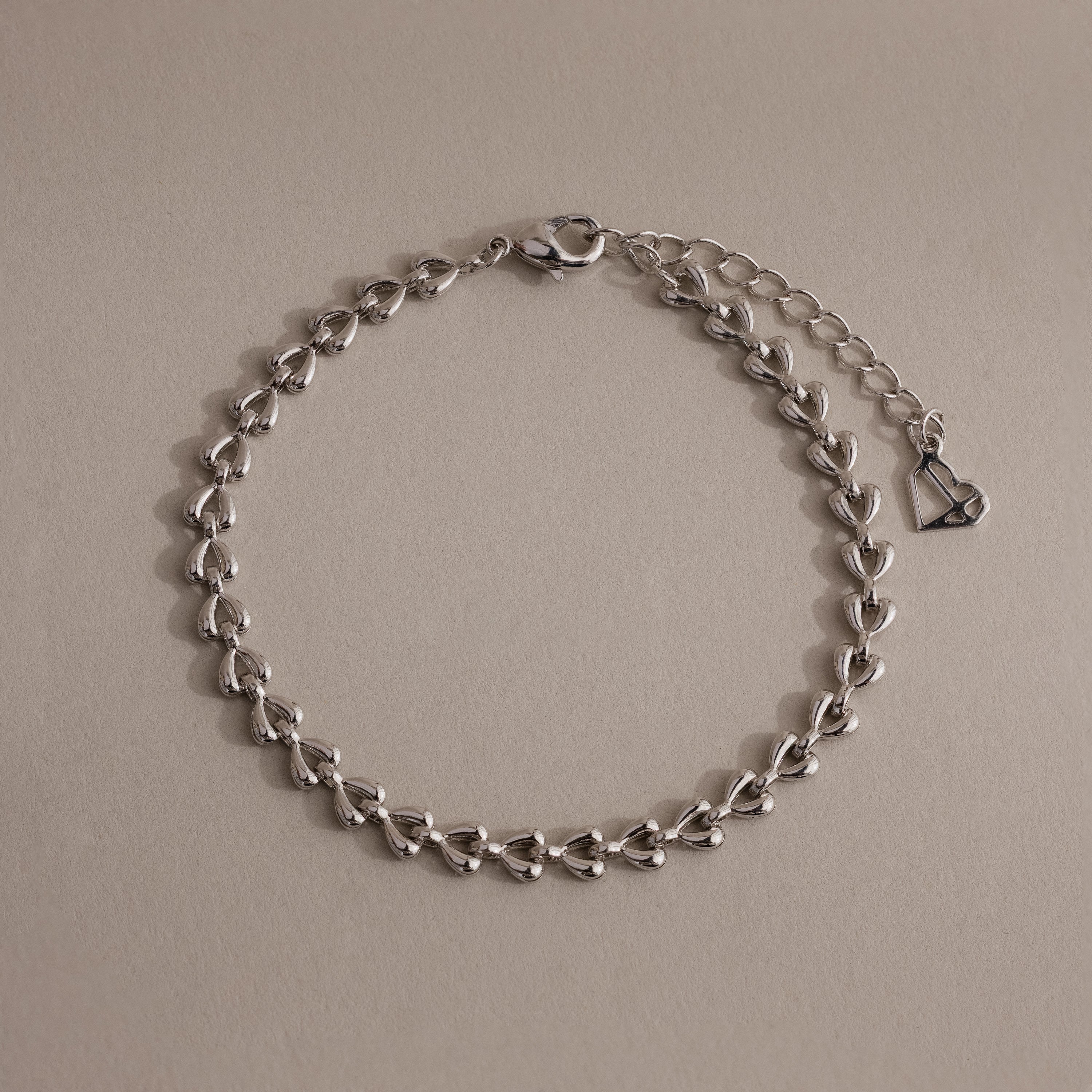 Silver Tiny Link Heart Bracelet displayed on a neutral background.