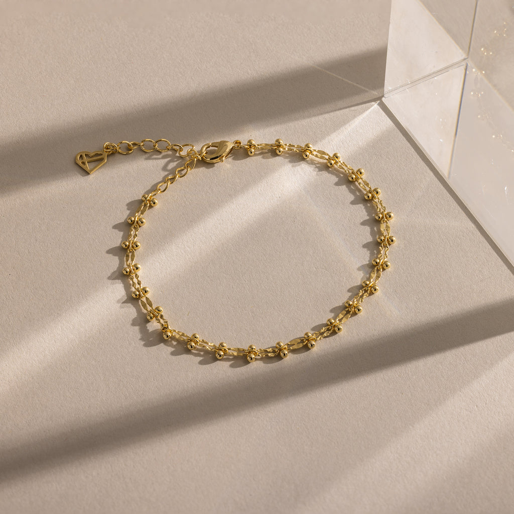 Close-up of a gold Dainty Mirror Chain Bracelet displayed on a neutral surface.