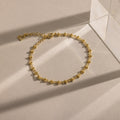 Close-up of a gold Dainty Mirror Chain Bracelet displayed on a neutral surface.