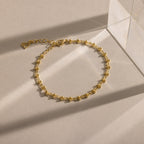 Close-up of a gold Dainty Mirror Chain Bracelet displayed on a neutral surface.