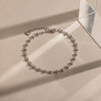 Close-up of a silver Beaded Mirror Chain Bracelet displayed on a neutral surface.