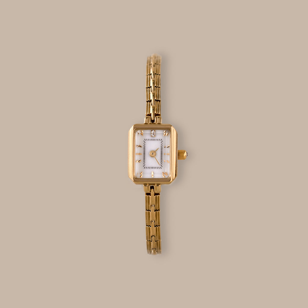 Divine Rectangular Link Timepiece with polished gold-tone case, white dial, and delicate link bracelet.