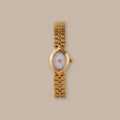 Flow Oval Link Timepiece: Gold-tone watch with petite oval dial and fluid multi-link bracelet.