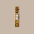 Gold tone Paragon Link Timepiece with rectangular dial, Roman numerals, and patterned links.