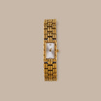 Gold tone Paragon Link Timepiece with rectangular dial, Roman numerals, and patterned links.