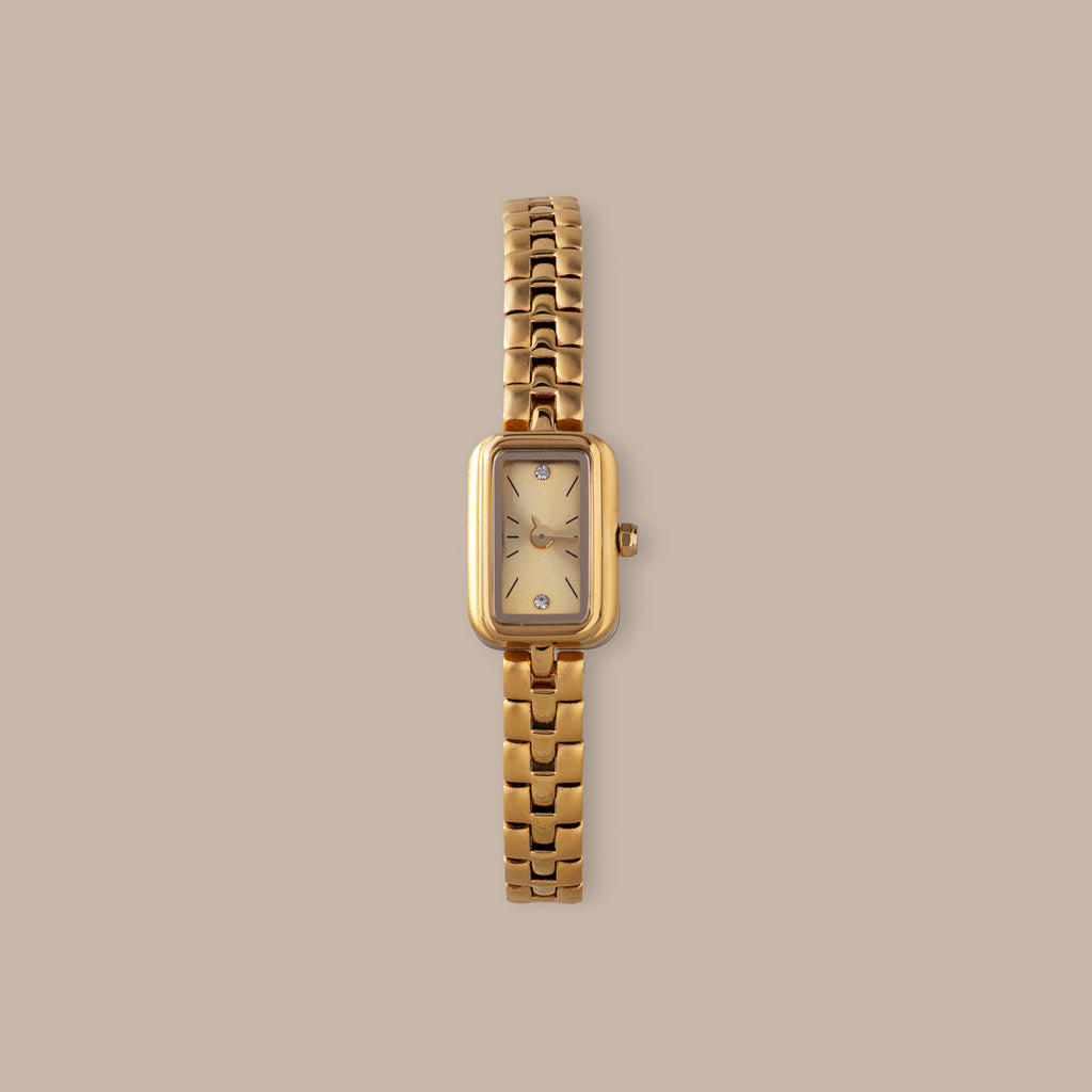 Gold-tone rectangular Harmony Link Timepiece with crystal markers and a polished finish.